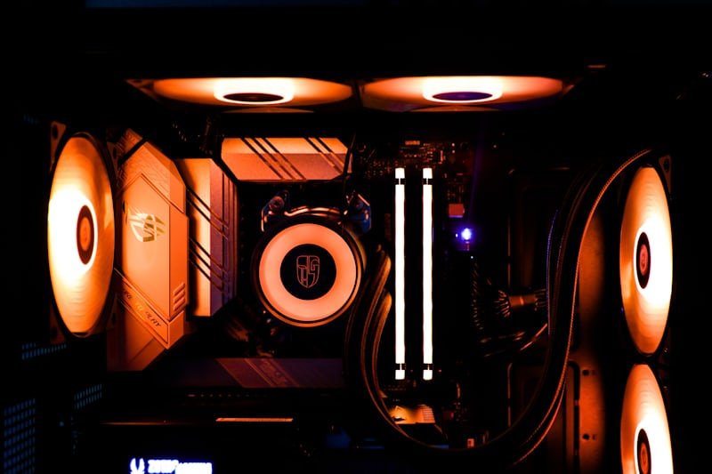 Gaming PC build interior lit with orange RGB lighting